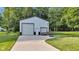 An outbuilding featuring two garage doors and a basketball hoop on a well-maintained lawn at 5710 W 650 N, Thorntown, IN 46071