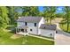 The rear exterior of this home features a covered porch and well manicured lawn at 5710 W 650 N, Thorntown, IN 46071