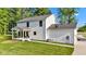The rear exterior of this home features a covered porch and a well manicured lawn at 5710 W 650 N, Thorntown, IN 46071