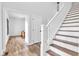 Well-lit staircase with wood treads and white risers, offering a classic design and seamless flow between levels at 5710 W 650 N, Thorntown, IN 46071