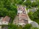 Aerial view showcasing a home with an extensive driveway, basketball court, and lush greenery at 5805 Forest Ln, Indianapolis, IN 46220
