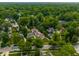 An aerial view of a quiet neighborhood filled with lush trees and well-maintained houses at 5805 Forest Ln, Indianapolis, IN 46220