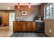 Basement wet bar boasts dark countertops and undercounter beverage refrigerator at 5805 Forest Ln, Indianapolis, IN 46220