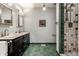 This bathroom features a double sink vanity, a large shower with tile surround, and a light green tile floor at 5805 Forest Ln, Indianapolis, IN 46220