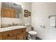 Bathroom featuring wooden vanity, a vanity mirror cabinet, and a traditional-style sink, offering a classic look at 5805 Forest Ln, Indianapolis, IN 46220