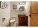 Charming powder room featuring a dark wood vanity and unique vessel sink at 5805 Forest Ln, Indianapolis, IN 46220