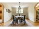 A dining room with hard wood floors, a vintage rug, and a chandelier at 5805 Forest Ln, Indianapolis, IN 46220