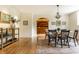 A dining room with hard wood floors, a chandelier, and an arched doorway at 5805 Forest Ln, Indianapolis, IN 46220
