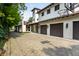 Spacious stone driveway and three-car garage with a basketball hoop near lush trees at 5805 Forest Ln, Indianapolis, IN 46220