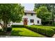 Charming two-story home featuring a brick-accented entryway and beautifully landscaped front yard with manicured hedges at 5805 Forest Ln, Indianapolis, IN 46220