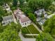 A captivating aerial view highlights the manicured front lawn and the home's classic architecture at 5805 Forest Ln, Indianapolis, IN 46220