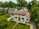 Home with meticulously landscaped yard, showcasing unique architectural accents and surrounding greenery at 5805 Forest Ln, Indianapolis, IN 46220