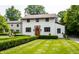 Charming two-story home featuring a brick-accented entryway and beautifully landscaped front yard with manicured hedges at 5805 Forest Ln, Indianapolis, IN 46220