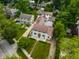 Aerial view showcasing a home with a well-kept lawn, unique architectural details, and surrounding greenery at 5805 Forest Ln, Indianapolis, IN 46220