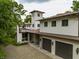 Exterior view of home featuring a tower, a three-car garage, and stone driveway at 5805 Forest Ln, Indianapolis, IN 46220
