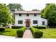 Charming two-story home featuring a brick-accented entryway and beautifully landscaped front yard with manicured hedges at 5805 Forest Ln, Indianapolis, IN 46220