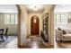 Welcoming foyer showcasing the arched entryway, stone floors, coat rack, and hardwood floors at 5805 Forest Ln, Indianapolis, IN 46220