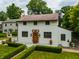 Charming home featuring a manicured lawn, brick-accented entrance, and classic architectural details at 5805 Forest Ln, Indianapolis, IN 46220