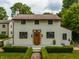 Classic home showcases a well-maintained lawn, distinctive front door, and traditional design elements at 5805 Forest Ln, Indianapolis, IN 46220