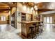 Spacious kitchen featuring a wooden island with bar stools, tile floors, and wood paneled ceiling with skylight at 5805 Forest Ln, Indianapolis, IN 46220