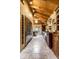 A long kitchen with stainless steel appliances, a wooden hutch, stone floors, and wood paneled ceilings at 5805 Forest Ln, Indianapolis, IN 46220
