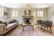 Bright living room featuring a fireplace, neutral couch, two armchairs and decorative accents at 5805 Forest Ln, Indianapolis, IN 46220