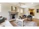 Inviting living room featuring a fireplace, neutral couch, two armchairs and decorative accents at 5805 Forest Ln, Indianapolis, IN 46220