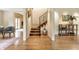 Spacious living room featuring hardwood floors, an staircase, and natural light at 5805 Forest Ln, Indianapolis, IN 46220