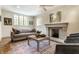 Inviting living room featuring a fireplace, neutral couch, two armchairs and decorative accents at 5805 Forest Ln, Indianapolis, IN 46220