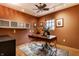 This office features a large desk, a ceiling fan, and windows that provide ample natural light at 5805 Forest Ln, Indianapolis, IN 46220
