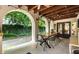 Inviting outdoor patio featuring a dining table, lush greenery, and warm ambiance at 5805 Forest Ln, Indianapolis, IN 46220