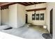 Spacious portico with three windows, wood beams, a unique light fixture, and concrete floors at 5805 Forest Ln, Indianapolis, IN 46220
