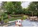 Backyard with a patio area, lush landscaping and mature trees for privacy at 6483 Royal Oakland Dr, Indianapolis, IN 46236
