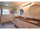 Bathroom featuring double sinks with granite counters and decorative mirrors at 6483 Royal Oakland Dr, Indianapolis, IN 46236