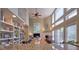 Open dining area with decorative bookcase, fireplace, and large windows offers bright space at 6483 Royal Oakland Dr, Indianapolis, IN 46236