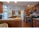 Modern kitchen with granite counters, stainless steel appliances, and wood floors at 6483 Royal Oakland Dr, Indianapolis, IN 46236