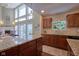 Gourmet kitchen with granite countertops, wood cabinets, and stainless steel appliances at 6483 Royal Oakland Dr, Indianapolis, IN 46236