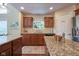 Well-appointed kitchen with granite countertops, wood cabinets, stainless steel appliances, and pantry at 6483 Royal Oakland Dr, Indianapolis, IN 46236