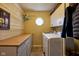 Functional laundry room with modern washer and dryer, storage cabinets, and counter space at 6483 Royal Oakland Dr, Indianapolis, IN 46236