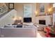Open concept living room with wood floors, neutral paint, fireplace, and plenty of natural light at 6483 Royal Oakland Dr, Indianapolis, IN 46236