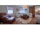 Comfortable living room with a white sofa, leather armchair, and a wooden coffee table on a rug at 6483 Royal Oakland Dr, Indianapolis, IN 46236