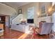 Open concept living room with wood floors, neutral paint, fireplace, and plenty of natural light at 6483 Royal Oakland Dr, Indianapolis, IN 46236