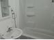 Compact bathroom with tiled shower/tub combo and pedestal sink at 6484 S State Road 39, Clayton, IN 46118