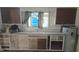 Vintage kitchen design with wooden cabinets, sink with window, and water heater at 6484 S State Road 39, Clayton, IN 46118