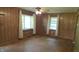 Spacious living area featuring wood paneling, hardwood floors, and plenty of natural light at 6484 S State Road 39, Clayton, IN 46118