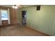 An open living space with wood-look laminate flooring and a glimpse into the kitchen at 6484 S State Road 39, Clayton, IN 46118