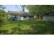 Rear exterior view of home and yard featuring a detached garage at 6484 S State Road 39, Clayton, IN 46118