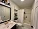 Updated bathroom with modern vanity, framed mirror, new lighting, and shower-tub combination at 6927 Havenmoor Pl, Indianapolis, IN 46250
