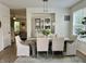 Dining area boasts a light wood table, chairs, overhead lighting and accent cabinet at 6927 Havenmoor Pl, Indianapolis, IN 46250