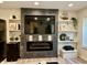 Modern fireplace with decorative shelves, television, and sleek design at 6927 Havenmoor Pl, Indianapolis, IN 46250